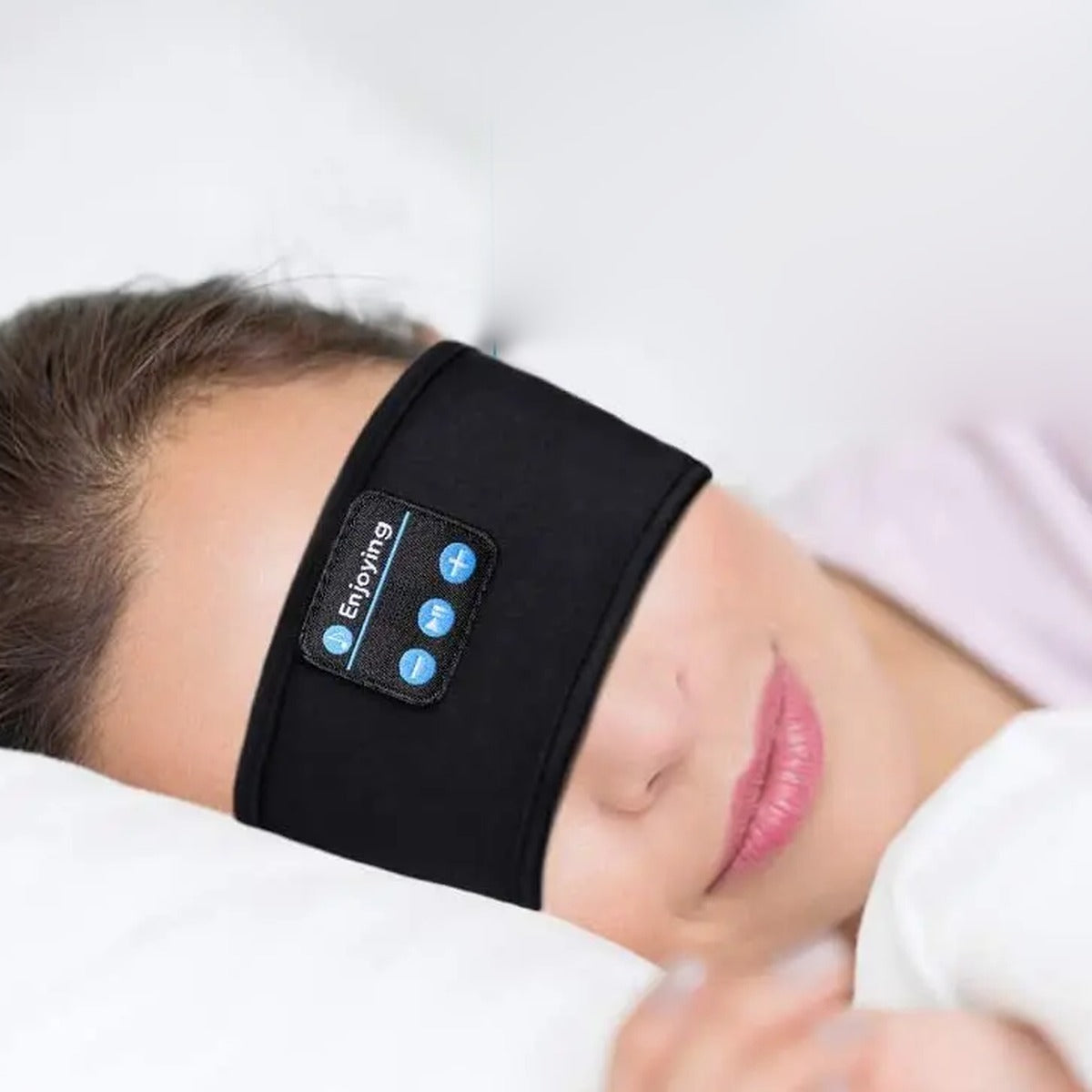 Woman side sleeping wearing the GlowRest Sleep Headband over her eyes