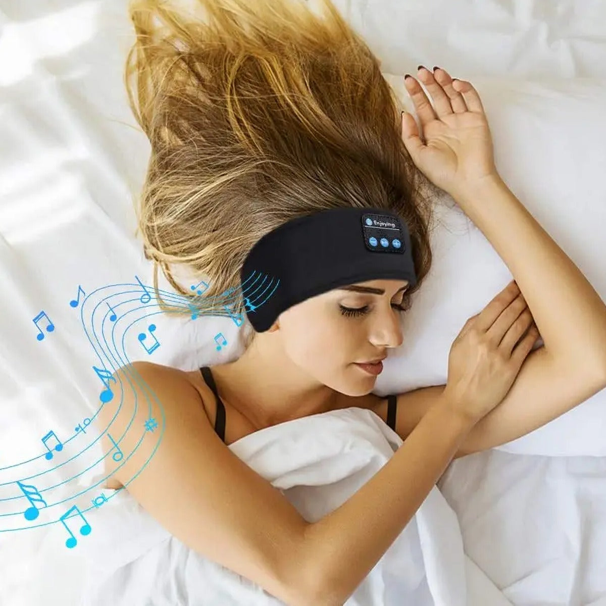 Woman in bed wearing the GlowRest Sleep Headband on her head